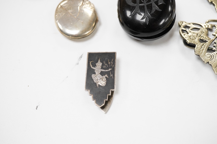 A group of jewellery, comprising: a locket, possibly in jet or bog oak, bearing the initials CIM, the interior with two compartments, length 4.6cm, design registration mark for circa 1861, maker's mark; three mechanical